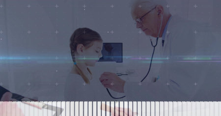 White coat doctor placing stethoscope on girl at medical desk, with tablet and monitor, copy space. Pediatric, healthcare, consultation, clinical, examination, professionalism, trustの写真素材