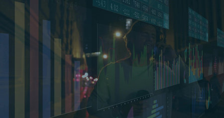 Wearing headphones, trader speaking into microphone at transparent desk display, floating charts. Finance, data analysis, technology, dashboard, urban, nightlife, professionalの写真素材