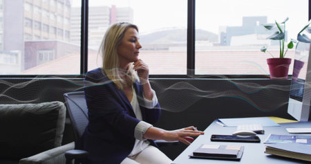 Resting businesswoman hovering over mouse at modern office desk, with monitor smartphones notebook....