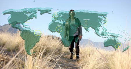 Walking Asian hiker wearing jacket on hillside, with backpack. Adventure, exploration, outdoor, wilderness, landscape, travel, horizonの写真素材