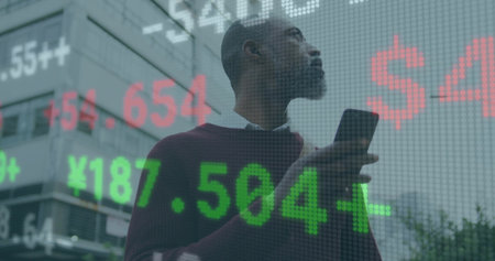 Analyzing executive in burgundy sweater scanning at urban plaza, with ticker overlay and smartphone. Enterprise, finance, investment, data, analysis, technology, professionalの写真素材