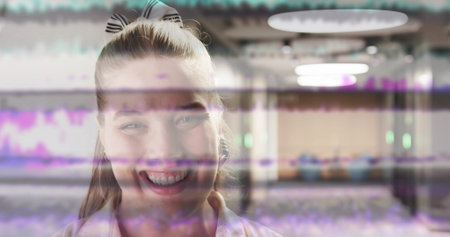 Smiling woman standing centrally in corridor, with scrunchie, glitch bars, lights, floor reflecting. Modern, minimalist, digital, futuristic, reflective, vibrant, urbanの写真素材