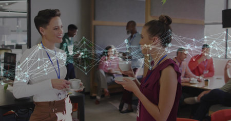 Networking colleagues with coffee cups discussing project in office lounge, network graphic. Collaboration, communication, technology, teamwork, modernity, corporate, interactionの写真素材