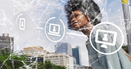 Leaning on urban plaza railing businesswoman in grey blazer examining network overlay, copy space....