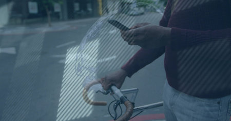 Man wearing burgundy sweater holding smartphone, bike at street corner with AR overlay, copy space. Urban, technology, modern, mobility, reflection, casual, professionalの写真素材