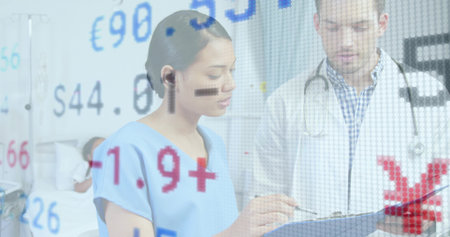 Discussing physician and patient reviewing clipboard details at hospital. Healthcare, consultation, medical, professional, clinical, hospital, patient careの写真素材