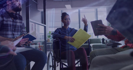 Leading meeting woman in wheelchair pointing finger in office lounge with yellow folder and tablet....