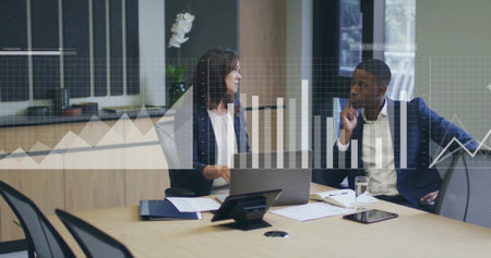 Colleagues in suits reviewing bar-line charts in office with laptop, tablet, documents, phone. Collaboration, analytics, teamwork, modern, professional, workspace, growthの写真素材