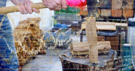 Swinging plaid-shirt man chopping wedge with axe on stump at shed. Firewood, outdoor, rustic, lumber, industry, manual labor, productivityの写真素材