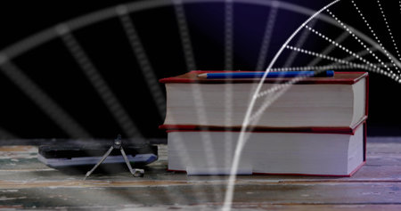 Displaying two red-bound books stacked on studio tabletop with blue pen, compass and calculator. Educational, academic, geometric, technical, vintage, creative, officeの写真素材