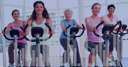 Pedaling five women in colorful outfits on stationary bikes in fitness studio, digital consoles....
