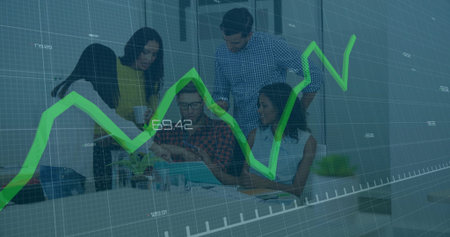 Collaborating coworkers reviewing financial data at conference table, with laptop and line graph....