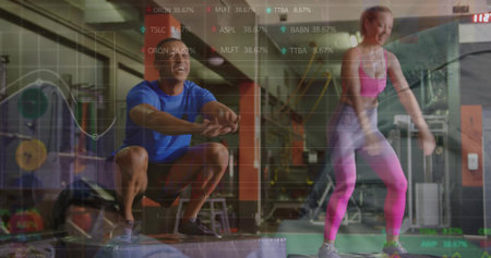 Performing box jumps fitness partners in sportswear at gym, with plyometric box and overlay charts. Athletic, training, dynamic, sport, strength, motivation, healthの写真素材