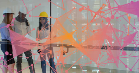 Three colleagues with hardhats reviewing plans in glass office, with digital overlay, copy space. Collaboration, architecture, urban, technology, teamwork, professional, modernの写真素材