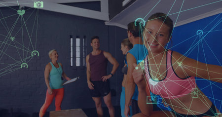 Leaning woman in sports bra giving thumbs up atop box at gym, with clipboard, copy space. Fitness, training, workout, strength, wellness, endurance, motivationの写真素材