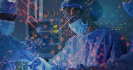 Performing surgeon wearing scrubs making incision in operating room, with instruments and monitors....