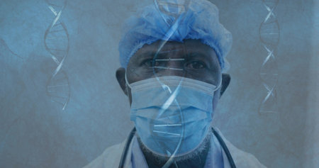 Male doctor studying floating DNA strands in lab, wearing surgical cap, face mask and stethoscope. Genetics, molecularbiology, research, healthcare, scientist, laboratory, innovationの写真素材
