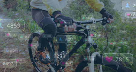 Riding cyclist wearing yellow cycling jacket on mountain bike along forest trail, with social icons. Adventure, fitness, outdoor, exploration, nature, activity, enduranceの写真素材