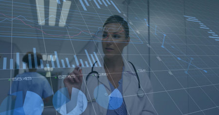 Woman physician with stethoscope manipulating interface charts in hospital corridor, with clipboard. Medical, healthcare, technology, analytics, professionalism, innovation, hospitalの写真素材