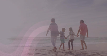Walking four barefoot family members holding hands on sandy beach, with ocean waves and horizon. Family, generational, leisure, outdoor, tranquility, unity, scenicの写真素材