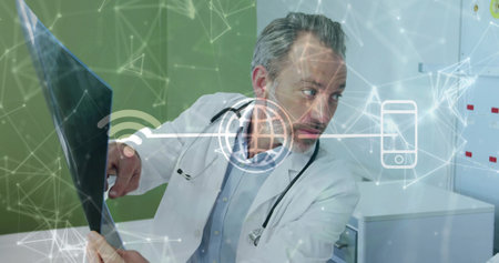 Displaying doctor pointing at radiograph wearing stethoscope in clinic, with digital network icons. Medical, healthcare, diagnostics, telemedicine, technological, professional, digitalの写真素材