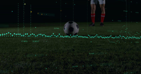 Sitting soccer ball on grass field at night, with green data visualization overlay. Athletic, performance, analytics, motion, competition, outdoor, dynamicの写真素材