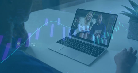 Joining online meeting on laptop showing two coworkers with succulent, financial charts in office....
