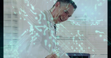 Smiling professional leaning over desk working on laptop in office, with circuit-pattern overlay....