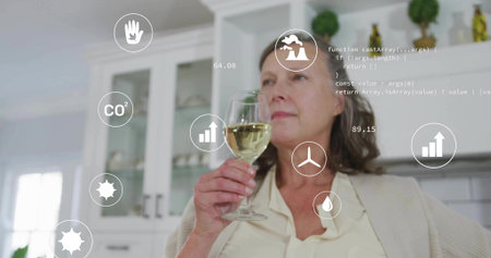 Sniffing senior woman analyzing wine aroma in modern kitchen, with digital metric icons, copy space. Contemplative, wellness, technology, lifestyle, aged, healthの写真素材