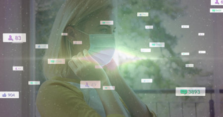 Securing surgical mask woman in yellow top by window, floating icons and lens flare, copy space. Health, wellness, telehealth, digital, technology, calm, optimisticの写真素材