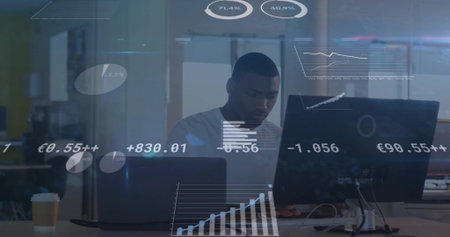 Analyzing data on dual monitors, man working in modern office, with digital overlays and coffee cup....