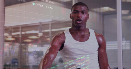 Panting athlete wearing white top lifting weights at gym. Fitness, strength, endurance, motivation, modern, urbanの写真素材