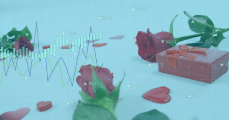 Red ribbon-tied gift box sitting on right of blue tabletop, with rose, hearts, copy space. Romance, celebration, elegance, gift, symbolism, decorationの写真素材