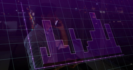 Business shirted man holding smartphone typing laptop in dim office at night, purple chart overlay. Technology, analytics, finance, data visualization, corporate, professional, nighttimeの写真素材