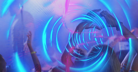 Couple forming heart shape with hands at music festival, with LED wristbands smartphone laser beams....