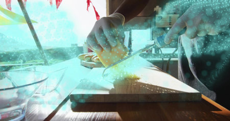 Slicing man wearing gloves at kitchen counter, with cutting board, cheese block and chef knife. Culinary, freshness, rustic, foodservice, preparation, rural, naturalの写真素材