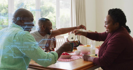 Woman pouring hot beverage from metal pot into mug at home wooden dining table with raspberries....