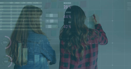 Collaborating two professionals writing data on conference glass wall, with marker and sticky notes. Collaboration, teamwork, innovation, data analysis, office, digital graphics, strategyの写真素材