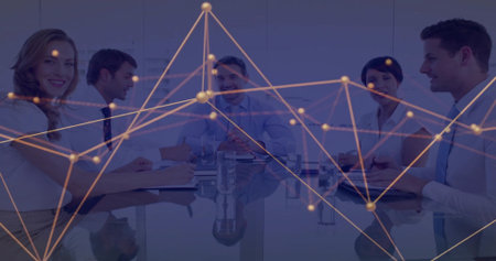 Colleagues discussing data around glass table in office, with notebooks, laptop and network overlay....
