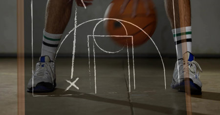 Legs of athlete dribbling orange basketball on court, with striped socks, blue shoes, chalk diagram. Sports, athleticism, training, game, competition, performance, exerciseの写真素材
