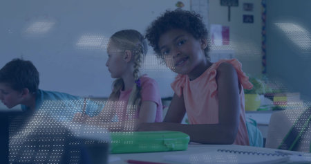 Smiling girl wearing pink top writing in classroom, with notebooks pencils posters, copy space. Children, education, learning, school, classroom, students, literacyの写真素材