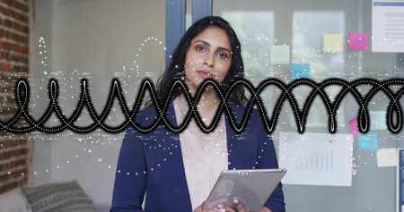 Holding tablet woman wearing navy blazer analyzing printed-chart on sticky-note partition in office. Corporate, innovation, modern, collaboration, data, communication, professionalの写真素材