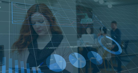 Red-haired woman writing in notebook with pen at office meeting with laptop and analytics overlays....