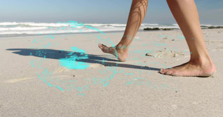 Walking female leaving footprints on wet sand at beach, with small mounds, ocean waves, copy space. Coastal, leisure, serene, natural, lifestyle, minimalism, tranquilityの写真素材