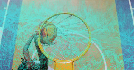Athlete in sleeveless top dunking basketball through rim at court, with backboard, net, court lines....