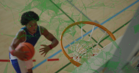 Dribbling blue jersey player on court under green overlay holding orange basketball, copy space. Athlete, sport, competition, fitness, game, training, agilityの写真素材