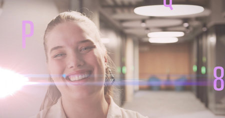 Smiling woman walking down office corridor with lens flare, floating letters P Q 8, copy space....
