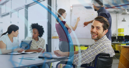 Man in wheelchair wearing plaid shirt taking notes in open-plan office, with flipchart, copy space. Collaboration, teamwork, corporate, business, modern, workplace, inclusiveの写真素材