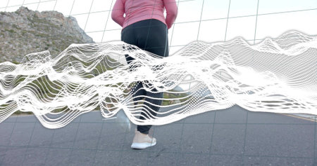 Standing runner wearing pink sports jacket, running shoes on mountain road, with waveform graphic....