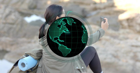 Holding smartphone hiker capturing selfie rocky shore, with mat backpack and headband, copy space. Adventure, exploration, outdoor recreation, nature, tranquility, wellness, landscapeの写真素材